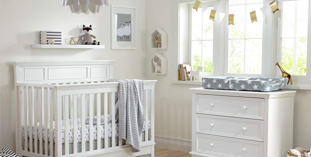 image of nursery scene with white crib and dresser. 